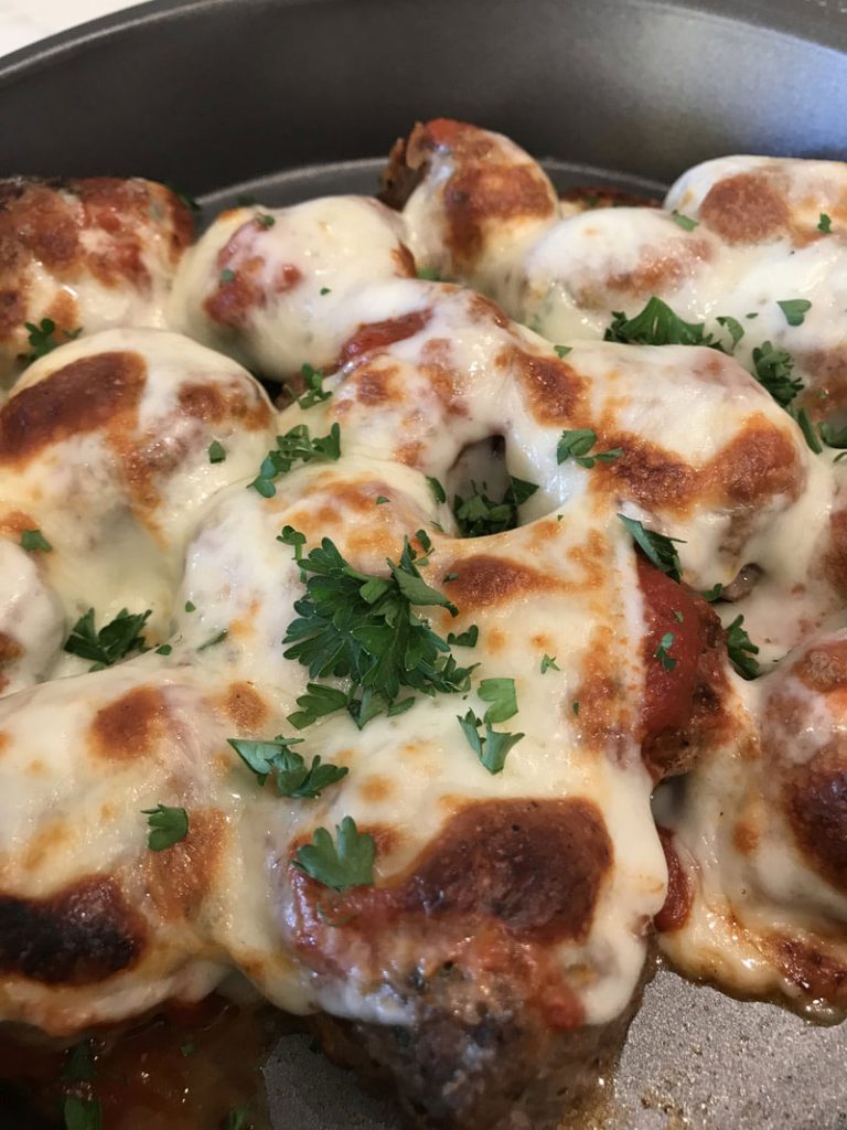 A close up of some food with cheese and parsley
