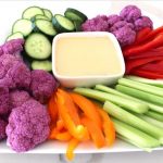 A plate of vegetables and dip on the side.